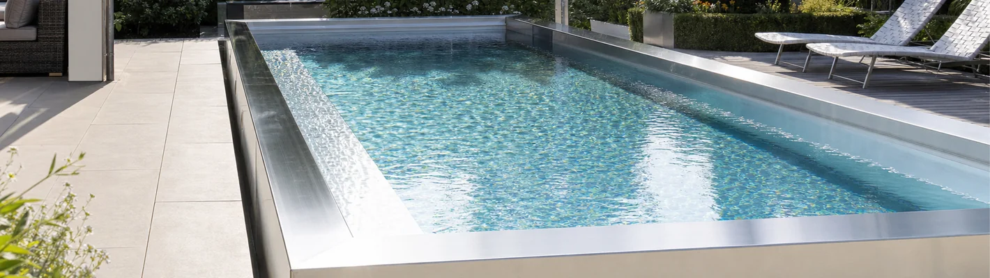 Edelstahl-Pool mit glänzender Wasseroberfläche im Sonnenlicht