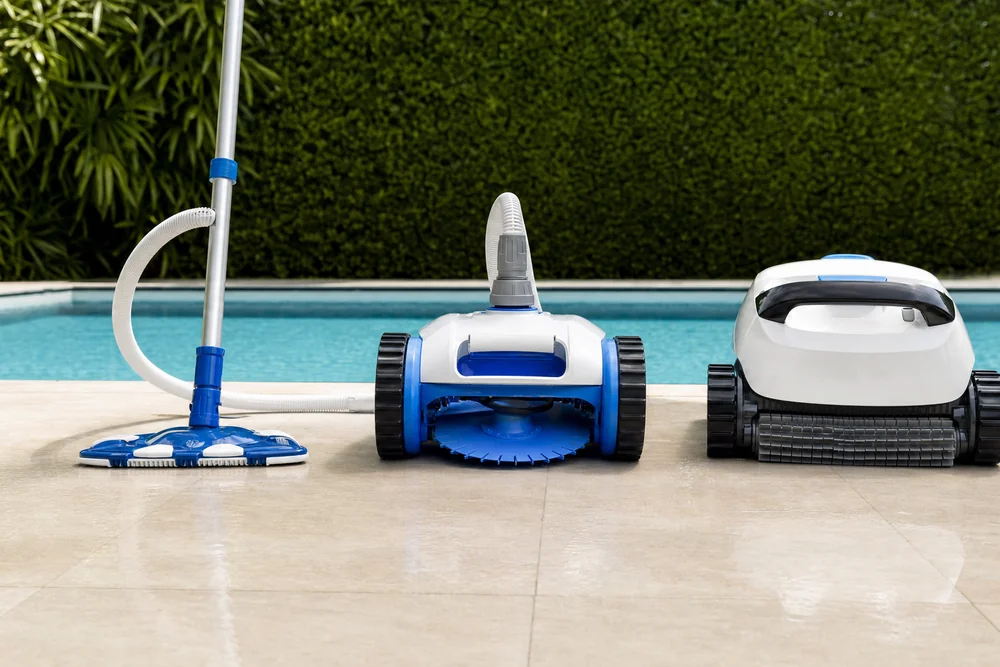 Drei Poolreiniger-Typen nebeneinander manueller Sauger druckseitig und elektrischer Roboter