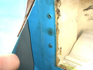 Detailansicht der Befestigungspunkte an der blauen Stahlwand eines Achtformbeckens, mit sichtbaren Schrauben.